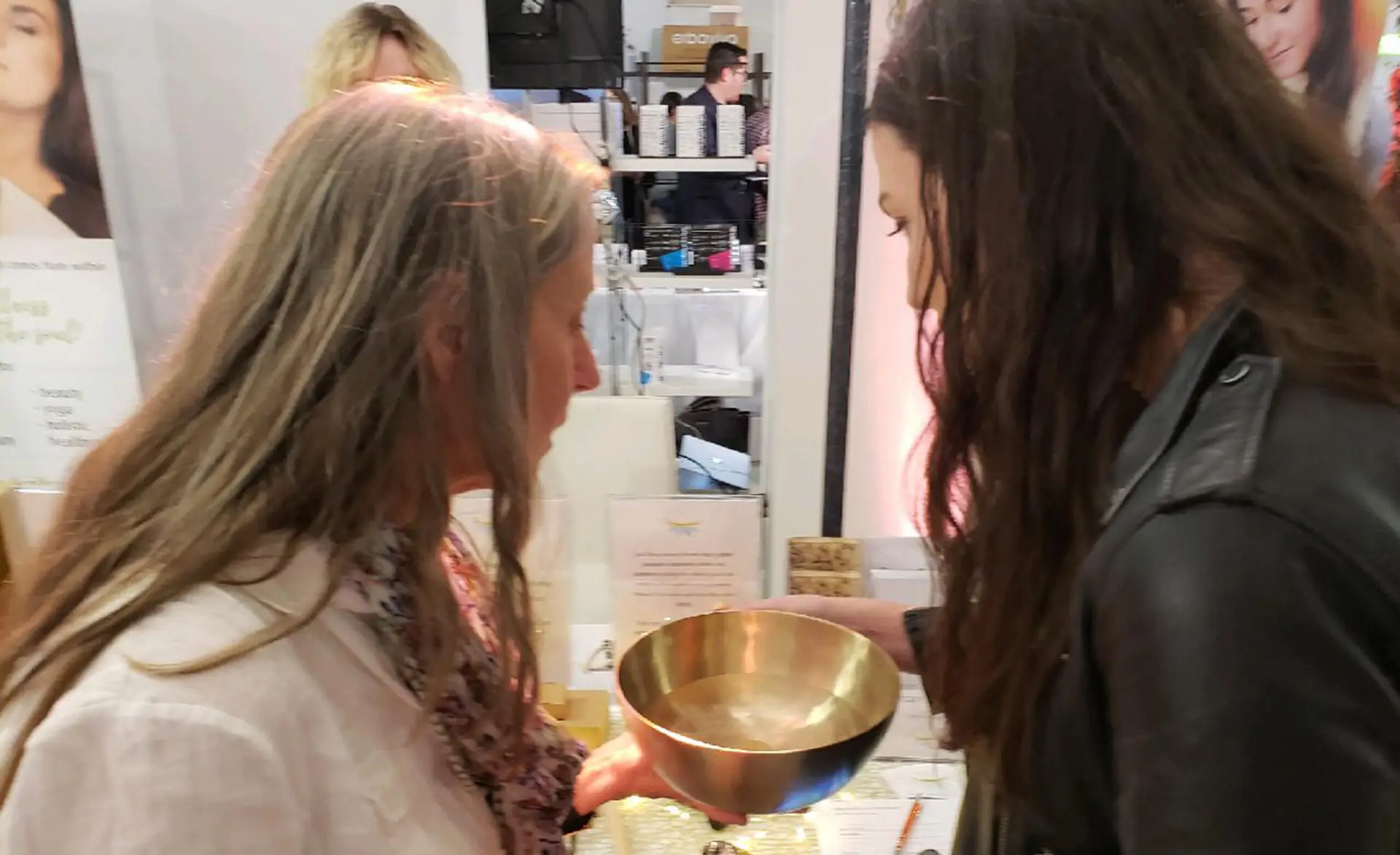 a singing bowl filled with water to explain the vibrational energy that is generated during a sound bath