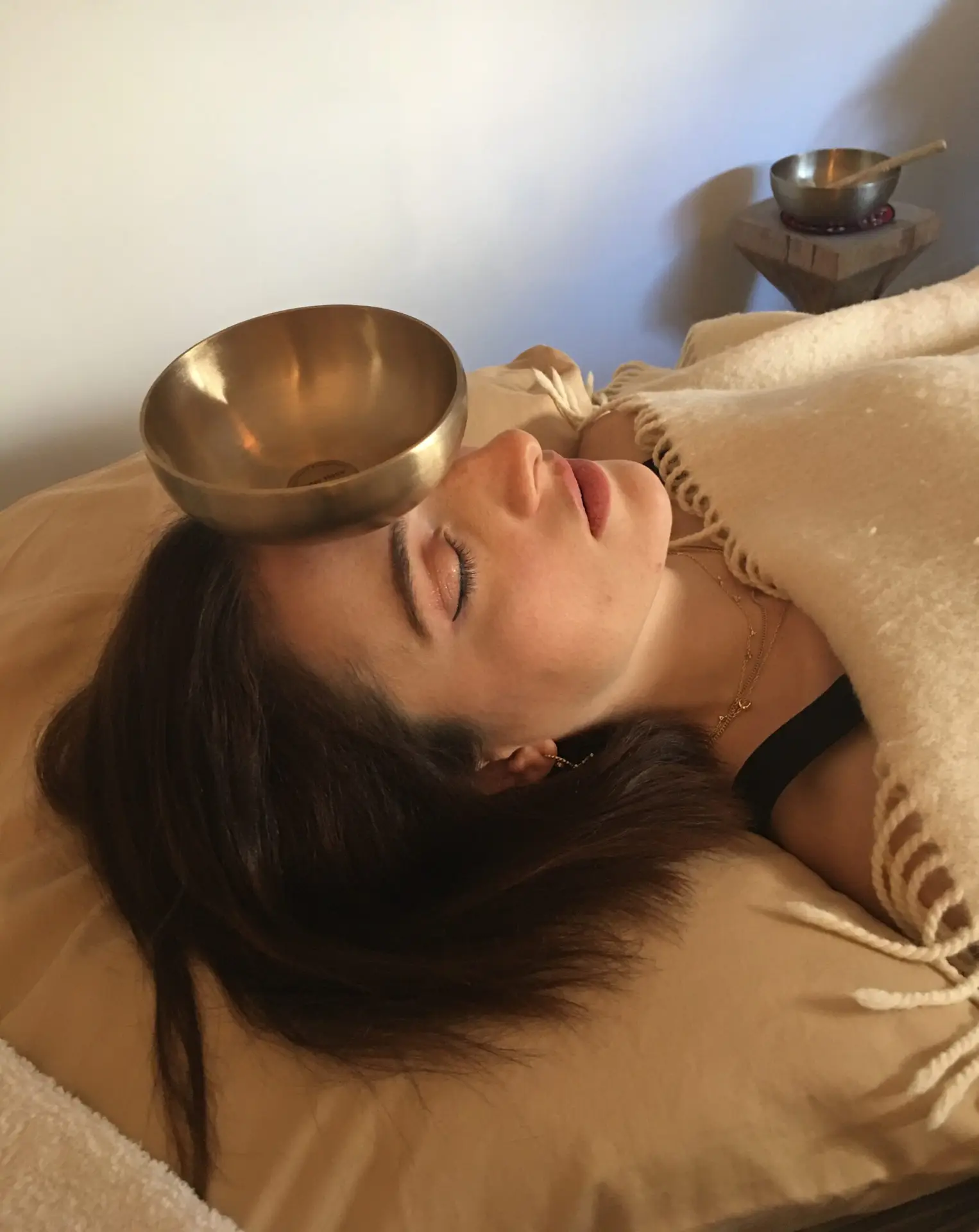 woman enjoying the vibration of the head singing bowl